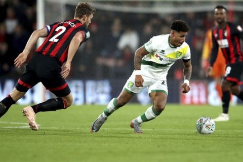 Norwich City's Onel Hernandez and Bournemouth's Simon Francis, left, battle for the ball during the round of 16 Football League Cup soccer match between Bournemouth and Norwich City, in Bournemouth, England, Tuesday, Oct. 30, 2018.  (Adam Davy/PA via AP)