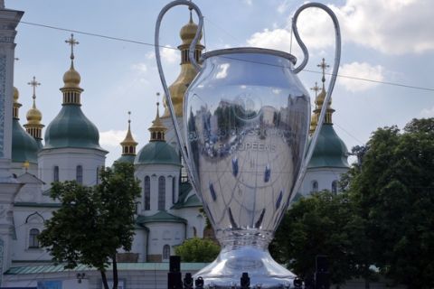 A huge replica of the Champions League trophy is placed in front of St. Sophia Cathedral, in Kiev, Ukraine, Wednesday, May 23, 2018. Liverpool will play Real Madrid in the Champions League Final on May 26 at the Olympiyski stadium in Kiev. (AP Photo/Efrem Lukatsky)