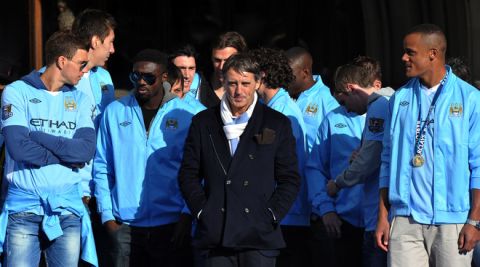 Manchester City players stand with their manager Roberto Mancini as they celebrate becoming English Premier League champions in a parade leaving from Mancheter Town Hall in Manchester, northwest England, on May 14, 2012. Manchester City beat their rivals Manchester United on goal difference to be crowned champions on the final day of the season with a 3-2 victory over Queens Park Rangers. AFP PHOTO/PAUL ELLISPAUL ELLIS/AFP/GettyImages