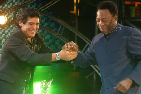 In this photo released by Canal 13, retired soccer legends, Argentina's Diego Maradona, left, and Brazilian Pele, shake hands during the premiere of Maradona's television show, "La Noche del 10" ("The Night of 10") in Buenos Aires, Monday, Aug. 15, 2005. Maradona hosted the star-studded TV talk show where Pele was the kickoff guest. The program, aired by local channel 13, was also graced by Argentine former tennis player Gabriela Sabatini and soccer player Gabriel Batistuta, and Italian actress Maria Grazia Cuccinota. (AP Photo/Canal 13)