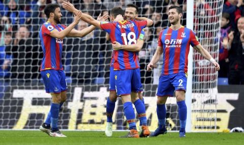 Crystal Palace's James McArthur, center, celebrates scoring his side's second goal of the game during their English Premier League soccer match Leicester City at Selhurst Park, London, Saturday, April 28, 2018. (Dominic Lipinski/PA via AP)