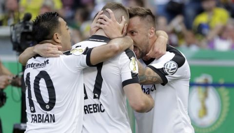 Frankfurt's scorer Ante Rebic, center, and his teammates Marco Fabian, left, and Haris Seferovic, right, celebrate their side's first goal during the German soccer cup final match between Borussia Dortmund and Eintracht Frankfurt in Berlin, Germany, Saturday, May 27, 2017. (AP Photo/Michael Sohn)