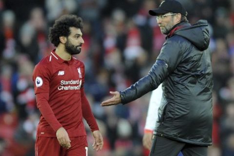 Liverpool manager Juergen Klopp, right, greets Liverpool's Mohamed Salah at the end of the English Premier League soccer match between Liverpool and AFC Bournemouth at Anfield stadium in Liverpool, England, Saturday, Feb. 9, 2019. (AP Photo/Rui Vieira)
