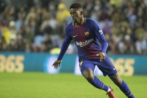 Barcelona's Ousmane Dembele chases the ball during a Copa del Rey round of 16, 1st leg soccer match between Celta and Barcelona at the Balaidos stadium in Vigo, Spain, Thursday Jan. 4, 2018. (AP Photo/Lalo R. Villar)