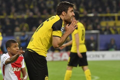 Dortmund's Sokratis Papastathopoulos communicates with the referee as Monaco's Kylian Mbappe, left, points at him during the Champions League quarterfinal first leg soccer match between Borussia Dortmund and AS Monaco in Dortmund, Germany, Wednesday, April 12, 2017. (AP Photo/Martin Meissner)