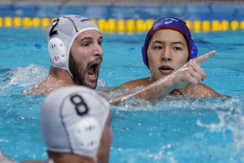 Greece's Konstantinos Genidounias (2) celebrates after scoring a goal against Japan during a preliminary round men's water polo match at the 2020 Summer Olympics, Thursday, July 29, 2021, in Tokyo, Japan. At right is Japan's Yusuke Inaba. (AP Photo/Mark Humphrey)