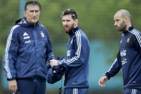 Argentina's coach Edgardo Bauza, left, forward Lionel Messi, center and Javier Mascherano stand on the field at the end of a training session in Buenos Aires, Argentina, Sunday, Nov. 13, 2016. Argentina will face Colombia for 2018 Russia World Cup qualifying soccer match Tuesday. (AP Photo/Natacha Pisarenko)