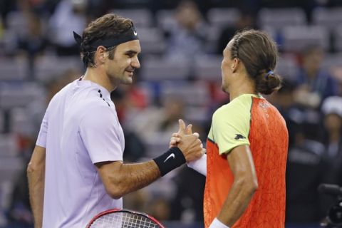 Roger Federer of Switzerland, left, shakes hands with his opponent Alexandr Dolgopolov of Ukraine after winning their men's singles match of the Shanghai Masters tennis tournament at Qizhong Forest Sports City Tennis Center in Shanghai, China, Thursday, Oct. 12, 2017. (AP Photo/Andy Wong)