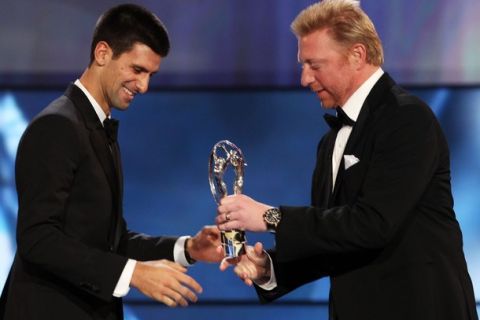 LONDON, ENGLAND - FEBRUARY 06:  Academy member Boris Becker hand over the trophy to tennis player Novak Djokovic winner of the Laureus World Sportsman of the Year on stage at the 2012 Laureus World Sports Awards at Central Hall Westminster on February 6, 2012 in London, England.  (Photo by Ian Walton/Getty Images for Laureus)
