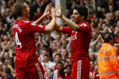 Liverpool's Luis Suarez, right, is celebrates with teammate Jordan Henderson after scoring against Wolverhampton Wanderers during their English Premier League soccer match at Anfield, Liverpool, England, Saturday Sept. 24, 2011. (AP Photo/Tim Hales)