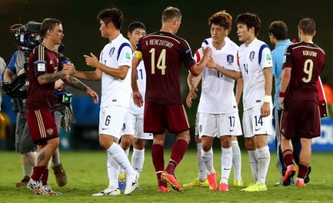 CUIABA, BRAZIL - JUNE 17:  Russia and Korea players interact after their 1-1 draw in the 2014 FIFA World Cup Brazil Group H match between Russia and South Korea at Arena Pantanal on June 17, 2014 in Cuiaba, Brazil.  (Photo by Elsa/Getty Images)