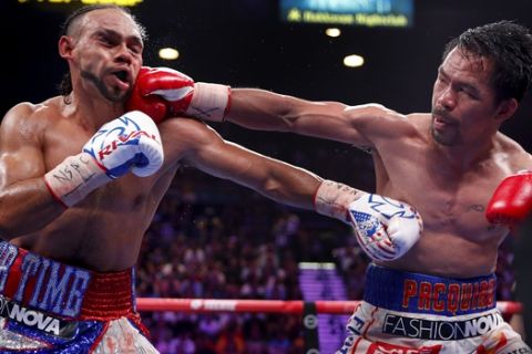 Manny Pacquiao, right, lands a punch against Keith Thurman in the 10th round of a welterweight title fight Saturday, July 20, 2019, in Las Vegas. (AP Photo/John Locher)