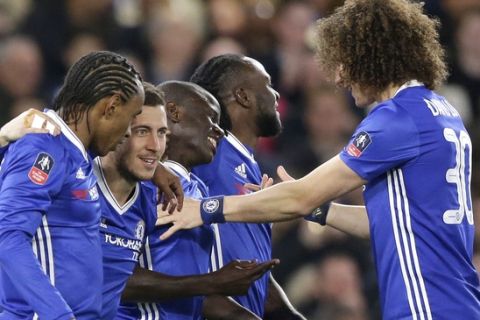 Chelsea's N'Golo Kante, centre, is congratulated by teammates after scoring a goal during the English FA Cup quarterfinal soccer match between Chelsea and Manchester United at Stamford Bridge stadium in London, Monday, March 13, 2017 (AP Photo/Alastair Grant)
