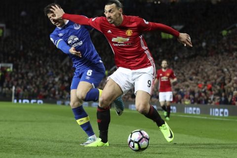 Everton's Ross Barkley, left, and Manchester United's Zlatan Ibrahimovic clash during their English Premier League soccer match between Manchester United and Everton at Old Trafford in Manchester, England, Tuesday April 4, 2017. (Martin Rickett/PA via AP)