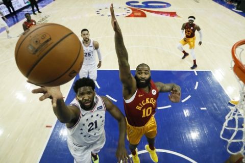 Philadelphia 76ers' Joel Embiid (21) goes up for a shot past Indiana Pacers' Kyle O'Quinn (10) during the first half of an NBA basketball game, Sunday, March 10, 2019, in Philadelphia. (AP Photo/Matt Slocum)
