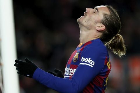 Barcelona's Antoine Griezmann reacts after failing to score during a Spanish La Liga soccer match between Barcelona and Granada at Camp Nou stadium in Barcelona, Spain, Sunday, Jan. 19, 2020. (AP Photo/Joan Monfort)
