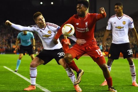 "LIVERPOOL, ENGLAND - MARCH 10:  Daniel Sturridge of Liverpool takes on Guillermo Varela (30) and Marcus Rashford of Manchester United (39) during the UEFA Europa League Round of 16 first leg match between Liverpool and Manchester United at Anfield on March 10, 2016 in Liverpool, United Kingdom.  (Photo by Laurence Griffiths/Getty Images)"