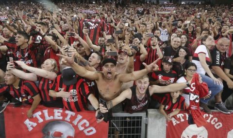 Fans of Brazil's Atletico Paranaense celebrate their team's 4-3 victory over Colombia's Junior after a penalty kick shoot-out, and clenching the title of the Copa Sudamericana tournament at Arena da Baixada stadium in Curitiba, Brazil, Thursday, Dec. 13, 2018. (AP Photo/Victor Caivano)