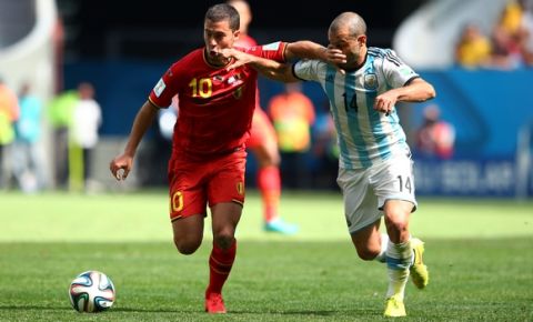 BRASILIA, BRAZIL - JULY 05: Eden Hazard of Belgium holds off the challenge of Javier Mascherano of Argentina during the 2014 FIFA World Cup Brazil Quarter Final match between Argentina and Belgium at Estadio Nacional on July 5, 2014 in Brasilia, Brazil.  (Photo by Julian Finney/Getty Images)