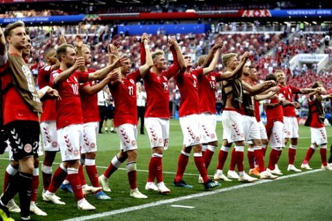 The Danish team as a group celebrate in front of their fans after the end of the group C match between Denmark and France at the 2018 soccer World Cup at the Luzhniki Stadium in Moscow, Russia, Tuesday, June 26, 2018. The game ended 0-0 . (AP Photo/Matthias Schrader)