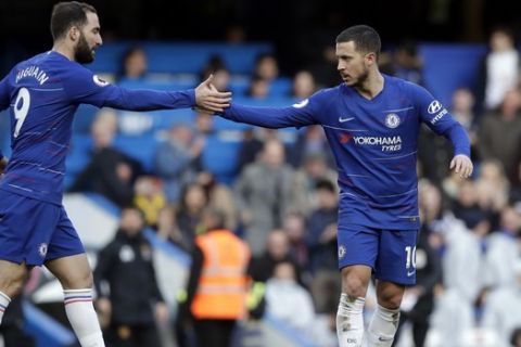 Chelsea's Eden Hazard, right, celebrates with Chelsea's Gonzalo Higuain after scoring his side's opening goal during the English Premier League soccer match between Chelsea and Wolverhampton Wanderers at Stamford Bridge stadium in London, Sunday, March 10, 2019. (AP Photo/Matt Dunham)