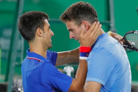 Juan Martin del Potro, of Argentina, cries while hugging Novak Djokovic, of Serbia, after defeating him in the men's tennis competition at the 2016 Summer Olympics in Rio de Janeiro, Brazil, Sunday, Aug. 7, 2016. (AP Photo/Vadim Ghirda)
