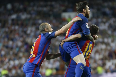 Barcelona's Lionel Messi, center, celebrates with his teammates Andres Iniesta and Jordi Alba, after scoring during a Spanish La Liga soccer match between Real Madrid and Barcelona, dubbed 'el clasico', at the Santiago Bernabeu stadium in Madrid, Spain, Sunday, April 23, 2017. (AP Photo/Francisco Seco)