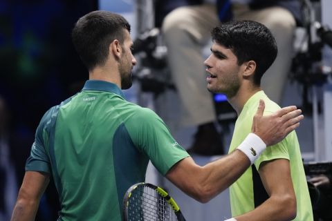 Serbia's Novak Djokovic, left, is congratulated by Spain's Carlos Alcaraz following their singles semifinal tennis match of the ATP World Tour Finals at the Pala Alpitour, in Turin, Italy, Saturday, Nov. 18, 2023. (AP Photo/Antonio Calanni)