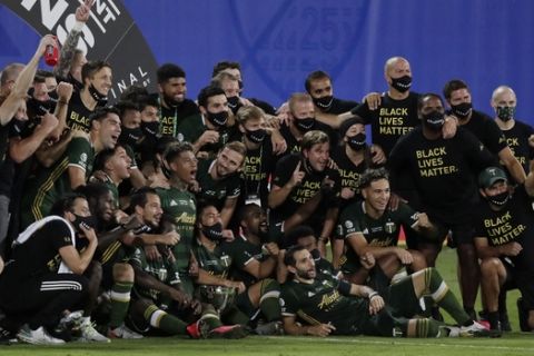 Portland Timbers players pose for photos after defeating Orlando City 2-1, during an MLS soccer tournament, Tuesday, Aug. 11, 2020, in Kissimmee, Fla. (AP Photo/John Raoux)