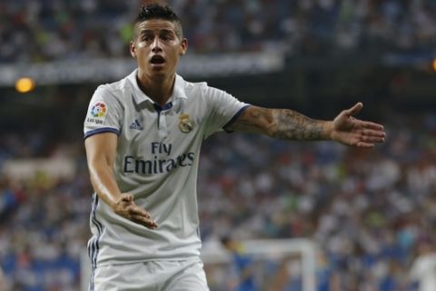 Real Madrid's James Rodriguez gestures to an assistant referee during the Spanish La Liga soccer match between Real Madrid and Celta Vigo at the Santiago Bernabeu stadium in Madrid, Saturday, Aug. 27, 2016. Real Madrid won 2-1. (AP Photo/Francisco Seco)