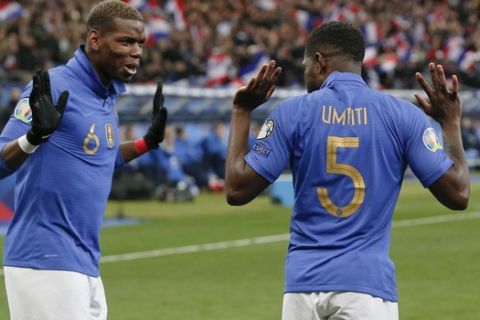 France's Samuel Umtiti, right, celebrates with France's Paul Pogba after scoring his side's first goal during the Euro 2020 group H qualifying soccer match between France and Iceland at Stade de France stadium in Saint Denis, outside Paris, France, Monday, March 25, 2019. (AP Photo/Michel Euler)