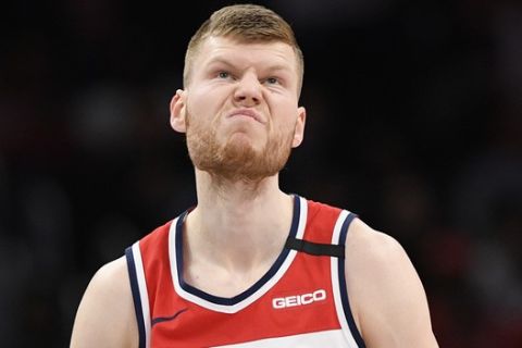 Washington Wizards forward Davis Bertans (42) stands on the court during the first half of an NBA basketball game against the Miami Heat, Sunday, March 8, 2020, in Washington. (AP Photo/Nick Wass)