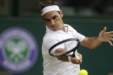 Switzerland's Roger Federer returns to Lucas Pouile of France in a Men's singles match during day six of the Wimbledon Tennis Championships in London, Saturday, July 6, 2019. (AP Photo/Tim Ireland)