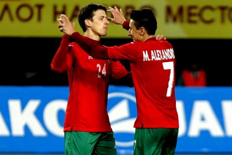 Bulgaria's Aleksandar Tonev, left, celebrates with teammate Mihail Alexandrov, right, after scoring the team's second goal against Macedonia in an international friendly soccer match at the Philip II Arena, in Skopje, Macedonia, Tuesday, March 29, 2016. (AP Photo/Boris Grdanoski)