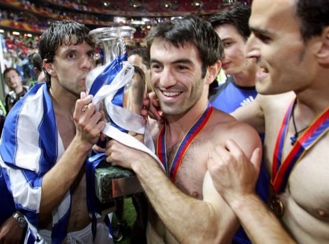 Greek midfielder Georgios Karagounis  holds the Henry Delaunay trophy, 04 July 2004 at the Luz stadium in Lisbon, at the end of the Euro 2004 final match between Portugal and Greece at the European Nations football championship in Portugal.  Greece won the match 1 to 0 to be crowned champions of Europe.  AFP PHOTO FRANCK FIFE