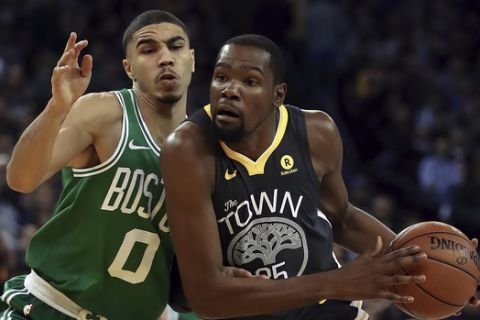 Golden State Warriors' Kevin Durant, right, drives the ball against Boston Celtics' Jayson Tatum (0) during the first half of an NBA basketball game Saturday, Jan. 27, 2018, in Oakland, Calif. (AP Photo/Ben Margot)