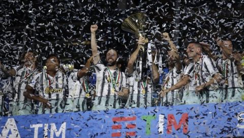 Juventus players celebrate winning an unprecedented ninth consecutive Italian Serie A soccer title, at the end of the a Serie A soccer match between Juventus and Roma, at the Allianz stadium in Turin, Italy, Saturday, Aug.1, 2020. (AP Photo/Luca Bruno)