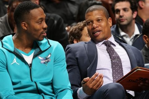 CHARLOTTE, NC - DECEMBER 4: Dwight Howard #12 talks with Assistant Coach Mike Batiste of the Charlotte Hornets during the game against the Orlando Magic on December 4, 2017 at Spectrum Center in Charlotte, North Carolina. NOTE TO USER: User expressly acknowledges and agrees that, by downloading and/or using this photograph, user is consenting to the terms and conditions of the Getty Images License Agreement. Mandatory Copyright Notice:  Copyright 2017 NBAE (Photo by Kent Smith/NBAE via Getty Images)