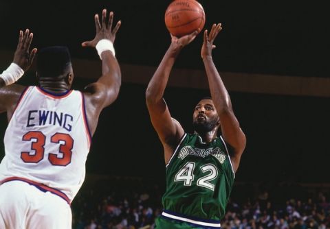 NEW YORK - 1990:  Roy Tarpley #42 of the Dallas Mavericks shoots a jump shot against Patrick Ewing #33 of the New York Knicks during a game played in 1990 at Madison Square Garden in New York, New York.  NOTE TO USER: User expressly acknowledges and agrees that, by downloading and/or using this Photograph, user is consenting to the terms and conditions of the Getty Images License Agreement.  Mandatory Copyright Notice:  Copyright 1990 NBAE  (Photo by Nathaniel S. Butler/NBAE via Getty Images)