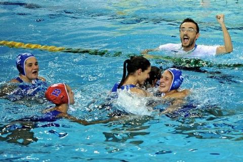 Greece's players celebrate with their coach George Morfesis after defeating China during their women's final water polo match of the FINA World Championships at the Oriental Sports Center in Shanghai on July 29, 2011. Greece won 9-8.  AFP PHOTO/PHILIPPE LOPEZ (Photo credit should read PHILIPPE LOPEZ/AFP/Getty Images)