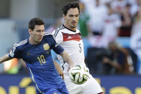 Argentina's Lionel Messi, left, and Germany's Mats Hummels go for the ball during the World Cup final soccer match between Germany and Argentina at the Maracana Stadium in Rio de Janeiro, Brazil, Sunday, July 13, 2014. (AP Photo/Victor R. Caivano)