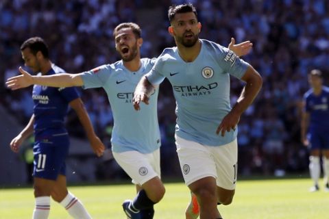 Manchester City's Sergio Aguero, front, celebrates scoring the first goal the game during the Community Shield soccer match between Chelsea and Manchester City at Wembley, London, Sunday, Aug. 5, 2018. (AP Photo/Tim Ireland)