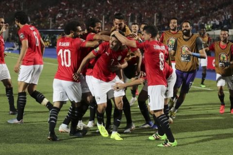 Egypt's players celebrate after they scored during the group A soccer match between Egypt and Zimbabwe at the Africa Cup of Nations at Cairo International Stadium in Cairo, Egypt, Friday, June 21, 2019. (AP Photo/Hassan Ammar)