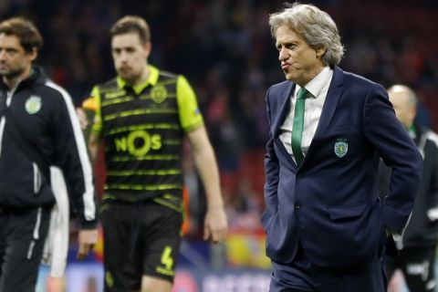 Sporting coach Jorge Jesus, right, and defender Sebastian Coates, 2nd left, walk on the pitch at the end of the Europa League quarterfinal first leg soccer match between Atletico Madrid and Sporting CP at the Metropolitano stadium in Madrid, Thursday, April 5, 2018. Atletico won 2-0. (AP Photo/Francisco Seco)