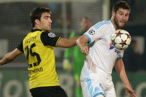 Dortmund's Greek defender Sokratis (L) vies with Marseille's French forward Andre-Pierre Gignac (R) on December 11, 2013 at the Velodrome stadium in Marseille, southern France, during the UEFA Champions League group F football match Olympique de Marseille vs Borussia Dortmund.      AFP PHOTO / ANNE-CHRISTINE POUJOULAT        (Photo credit should read ANNE-CHRISTINE POUJOULAT/AFP/Getty Images)