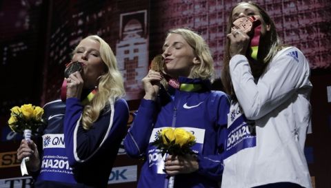 Medalists in the women's pole vault Anzhelika Sidorova, who participates as a neutral athlete, gold, center, Sandi Morris of the United States, silver, left, and Katerina Stefanidi of Greece, bronze, take part in the medal ceremony at the World Athletics Championships in Doha, Qatar, Monday, Sept. 30, 2019. (AP Photo/Nariman El-Mofty)