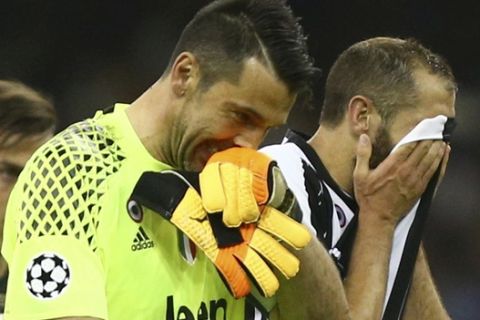 Juventus goalkeeper Gianluigi Buffon and Juventus' Giorgio Chiellini react at the end of the Champions League final soccer match between Juventus and Real Madrid at the Millennium stadium in Cardiff, Wales Saturday June 3, 2017. (AP Photo/Dave Thompson)