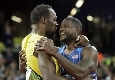 Gold medal winner United States' Justin Gatlin, right, embraces Jamaica's Usain Bolt who won bronze after the men's 100m final during the World Athletics Championships in London Saturday, Aug. 5, 2017. (AP Photo/Matt Dunham)