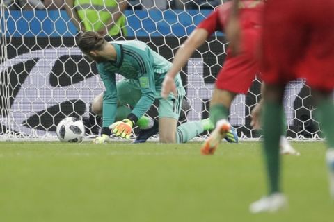 Spain goalkeeper David De Gea looks round as he fails to save a goal by Portugal's Cristiano Ronaldo, unseen, during the group B match between Portugal and Spain at the 2018 soccer World Cup in the Fisht Stadium in Sochi, Russia, Friday, June 15, 2018. (AP Photo/Sergei Grits)