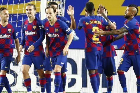 FC Barcelona's Antoine Griezmann, second left, celebrates after scoring his side's second goal during the Spanish La Liga soccer match between FC Barcelona and Leganes at the Camp Nou stadium in Barcelona, Spain, Tuesday, June 16, 2020. (AP Photo/Joan Montfort)